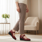 Pair of red Elara elegant mid-heel shoes, front view, showcasing the smooth leather and adjustable strap detail.