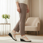 Overhead shot of beige Elara elegant mid-heel shoes, emphasizing the natural leather texture and classic design.