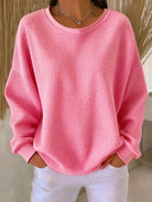 Diverse group of women wearing the Soraya knitted wide collar sweater in various colors, showcasing versatility.