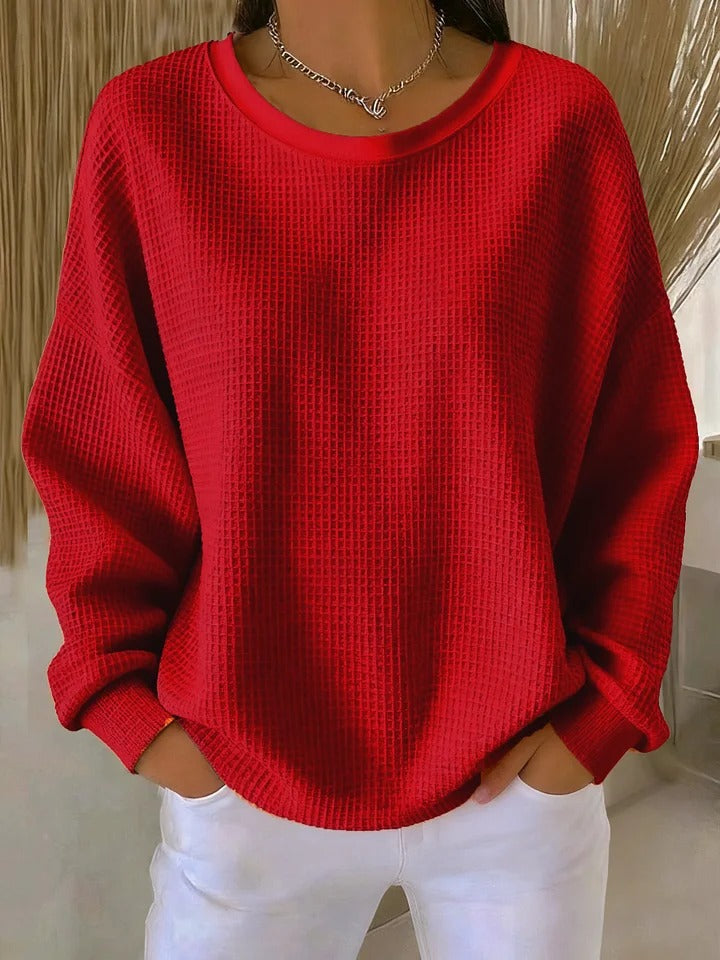 Side profile of the Soraya knitted wide collar sweater, highlighting the gentle drape and visible knit texture.