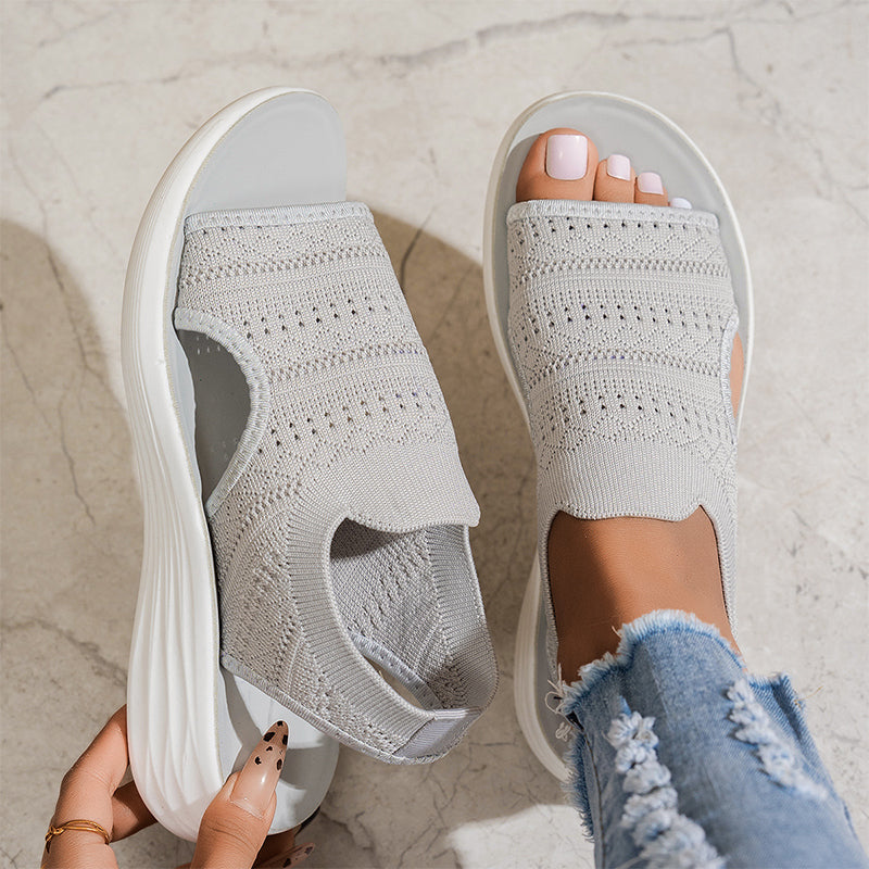 Close-up of the breathable knit upper on a pink pair of walking sandals, emphasizing the intricate weave.