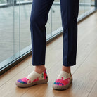 Close-up of the breathable mesh upper texture and vibrant artistic pattern of the slip-on shoes
