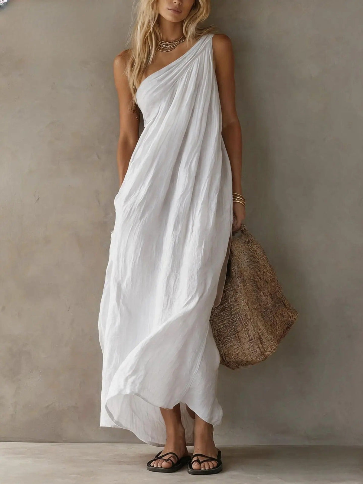 Vibrant yellow cotton-linen one-shoulder maxi dress, flowing gracefully from the front, ideal for summer events.