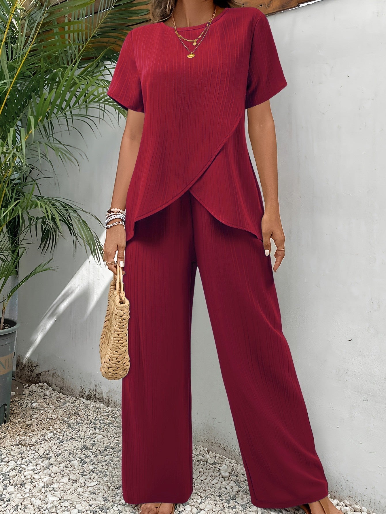 Close-up of the breathable fabric texture on elegant green wide-leg pants.
