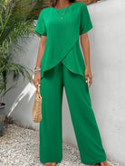 Side view of a woman walking in navy wide-leg pants, showcasing the relaxed drape.