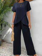 Burgundy wide-leg pants folded neatly, highlighting the lightweight material.