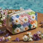 Close-up of a Yara quilted cosmetic bag in a vibrant petal path print, showcasing the fabric texture and design details.
